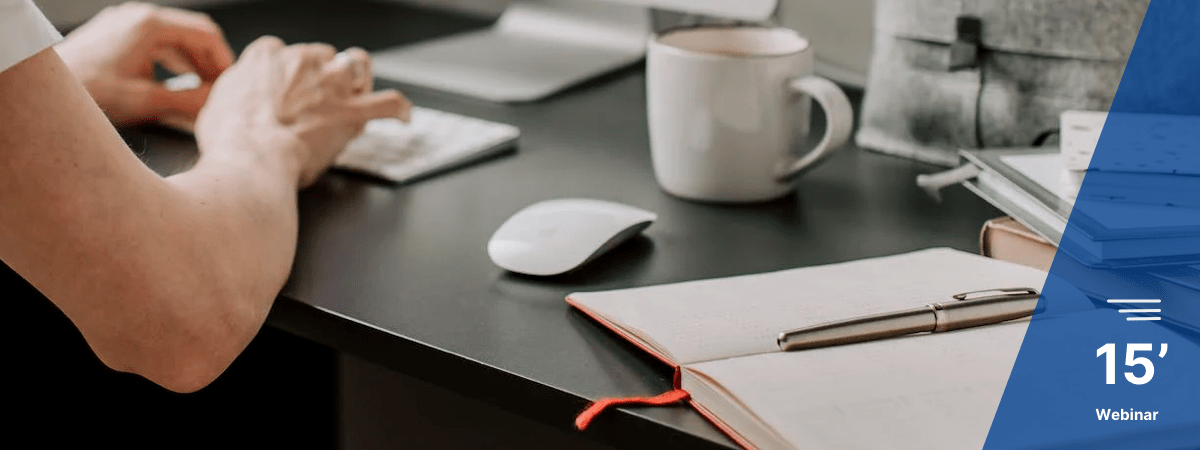 A man typing next to an agenda and a pen to represent revision of AIIG contracts